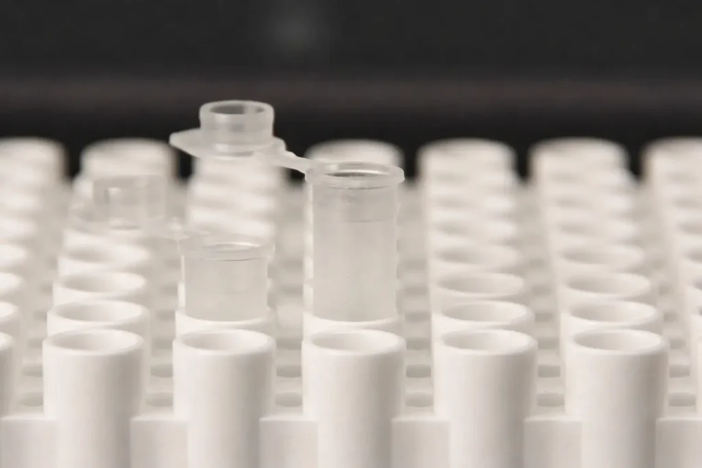 PCR tubes placed in a rack with one tube open, showing typical laboratory handling setup
